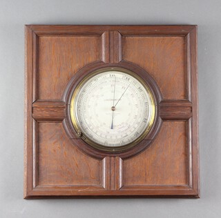 Negretti and Zambra, a land barometer, the 20cm silvered dial marked 3402, contained in an oak panelled frame 48cm x 48cm, split to the bottom of the frame 