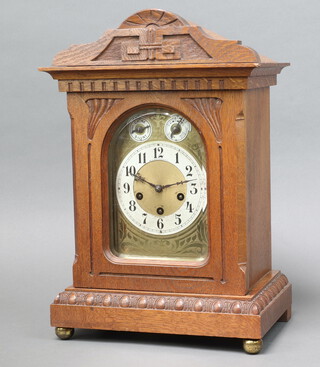 Junghans, an Art Nouveau chiming bracket clock, the 16cm arched dial with silent/chime/slow/fast dial marked H J Darracot, contained in a carved oak case 47cm h x 30cm w x 21cm d, complete with pendulum and key 