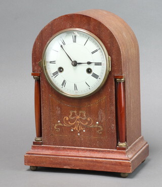 An Edwardian French striking mantel clock with 12cm enamelled dial, Roman numerals, contained in an inlaid mahogany arch shaped case, complete with pendulum and key 30cm h x 22cm w x 13cm d  