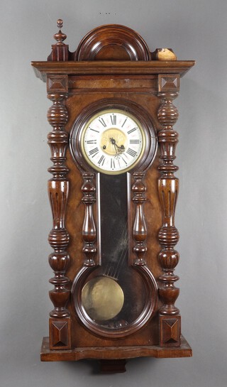 A Vienna style regulator wall clock with 18cm paper dial, Roman numerals contained in a walnut case with non fitting grid iron pendulum, 91cm h x 47cm w x 18cm d, complete with pendulum and key 
