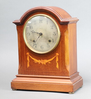 Ansonia, an Edwardian 8 day striking mantel clock with 15cm silvered dial, Arabic numerals contained in an arched inlaid mahogany case 35cm h x 27cm w x 14cm d, complete with pendulum by no key 