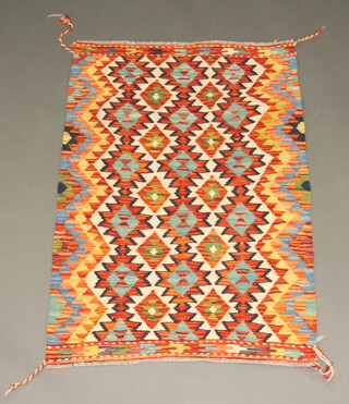 A green, orange and white ground Chobi Kilim rug with all over geometric design 118cm x 82cm 