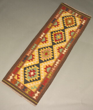 A black, brown, green and tan ground Maimana Kilim runner with 4 diamonds to the centre 196cm x 70cm 