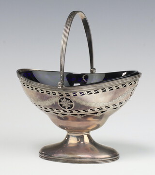 A Victorian oval pierced silver boat shaped sugar bowl with swing handle, Birmingham 1862 by S Blanckensee  & Sons, with blue glass liner, 132 grams  