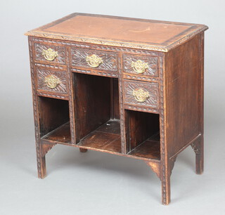 A Victorian carved oak desk with inset writing surface, fitted 5 drawers above 3 recesses 75cm h x 43 w x 43cm d 