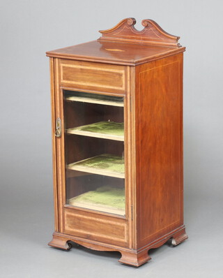 An Edwardian inlaid and crossbanded mahogany music cabinet with raised back, fitted shelves enclosed by a bevelled plate glazed panelled door, raised on ogee bracket feet 102cm h x 46cm w x 40cm d (sun bleached  in places) 