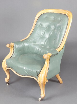 A Victorian bleached mahogany show frame armchair upholstered in turquoise buttoned leather, the seat of serpentine outline, raised on cabriole supports 107cm h x 71cm w x 59cm d 