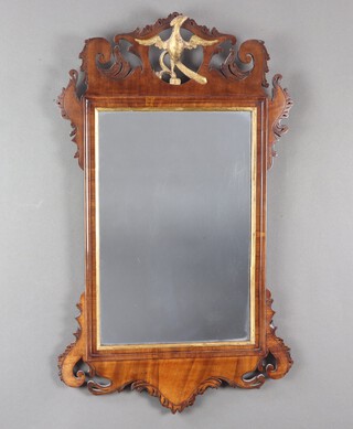 A 19th Century Chippendale style rectangular plate mirror contained in a walnut frame surmounted by a gilt eagle 79cm h x 46cm d  