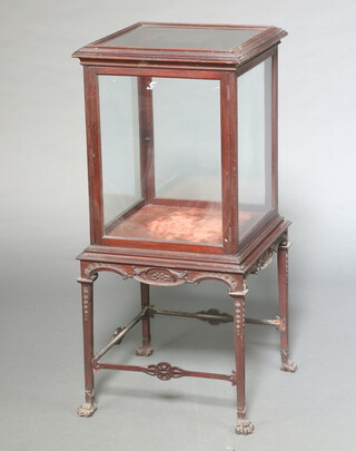 An Edwardian Chippendale style mahogany and glazed pedestal display cabinet enclosed by a panelled door, raised on square tapered supports, paw feet 107cm h x 48cm x 48cm 