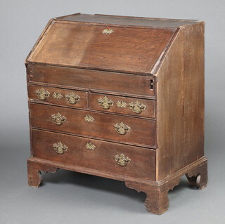 An 18th Century oak bureau, the fall front revealing a stepped interior with well above 2 short and 2 long drawers, raised on bracket feet 101cm h x 91cm w x 54cm d 