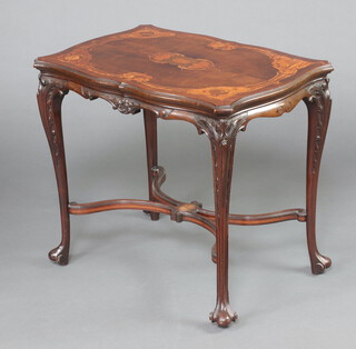 A Victorian shaped and carved inlaid mahogany occasional table raised on cabriole supports with X framed stretcher 65cm h x 74cm w x 52cm d 