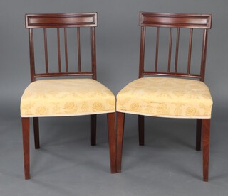 A pair of 19th Century  mahogany stick and rail back dining chairs with over stuffed seats, raised on square tapered supports 88cm h x 51cm w x 43cm d (seats 23cm x 29cm) 