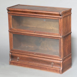 A 2 tier oak Globe Wernicke bookcase the base fitted a drawer 85cm h x 86cm w x 30cm d 