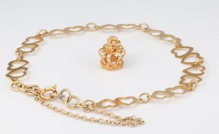A yellow metal charm in the form of a crown together with a yellow metal bracelet of heart shaped links, gross weight 4.1g