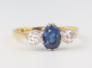 An 18ct yellow gold dress ring set an oval sapphire supported by 2 diamonds, gross weight 3.2g, size R 