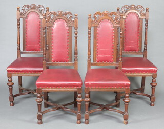 A set of 4 Edwardian oak Carolean style high back chairs raised on turned supports with X framed stretcher, cup and cover supports, seats and backs upholstered in red material 110cm h x 46cm w x 44cm d (seat 24cm x 29cm) 