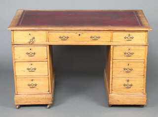 A Victorian light oak desk with red leather writing surface fitted 1 long and 8 short drawers 72cm h x 118cm w 71cm d 