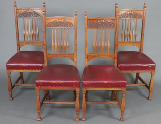 A set of 4 Art Nouveau oak stick and rail back dining chairs, the seats upholstered in red material on square supports with H framed stretcher 107cm h x 46cm w x 45cm d (seats 22cm x 27cm) 