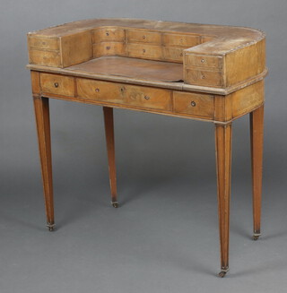 An Edwardian bleached mahogany Carlton House desk, the arched back fitted 12 drawers, the base fitted 1 long and 2 short drawers, raised on square tapered supports  88cm h x 95cm w x 46cm d 