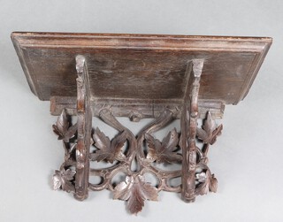 A Victorian carved oak bracket with vinous decoration 23cm h x 39cm w x 21cm d 