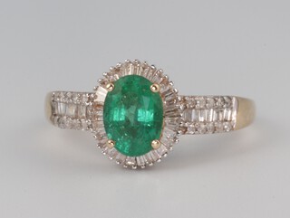 A 9ct yellow gold oval emerald and diamond cluster ring, the centre stone approx. 1.25ct surrounded by tapered baguette and brilliant cut diamonds approx. 0.75ct, 2.6 grams, size I 1/2
