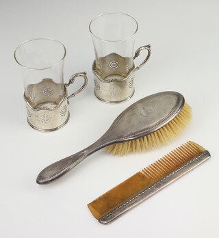A pair of silver cup holders Birmingham 1937, 143 grams together with a silver mounted brush and comb 