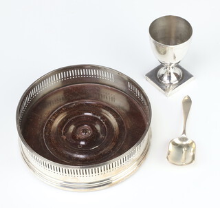 A George III silver cup on a square base, London 1799, ditto caddy spoon and bottle coaster 