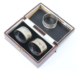 A pair of silver serviette rings Birmingham 1930, 1 other, 59 grams 