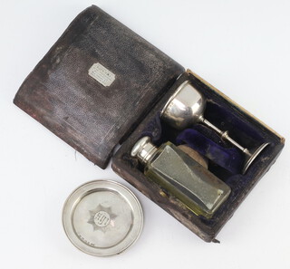 A Victorian silver travelling communion set comprising cup, platter and a mounted bottle (unmarked), weighable silver 52 grams, contained in a distressed case