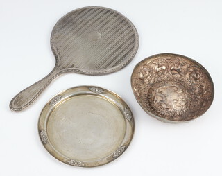 An Israeli white metal dish, a repousse bowl and a silver backed hand mirror, weighable items 185 grams 