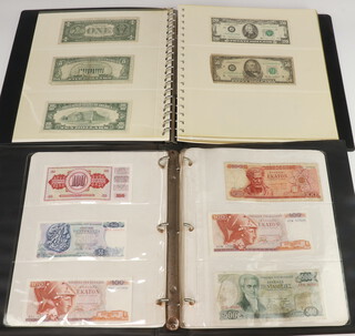 Two albums of bank notes including United Kingdom face value one hundred and other world bank notes pounds 