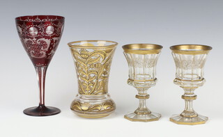 A pair of 19th Century Bohemian gilt glasses with vinous decoration on octagonal bases 14cm, ditto vase 13cm and a red wine 15cm 