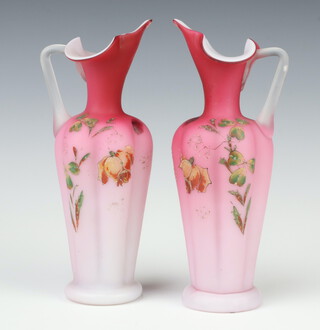 A pair of Victorian pink opaque glass ewers decorated with flowers 22cm 
