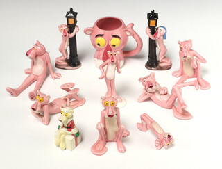 A collection of 10 Japanese porcelain figures of The Pink Panther marked United Artists - 2 standing behind a lamp post, 3 lying down, 3 sitting down, 1 standing a mug and similar figure
