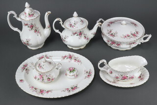 A Royal Albert Lavender Rose tea and dinner service comprising 6 tea cups, 6 saucers, 6 2 handled bowls, 10 saucers, 6 small plates, 6 dinner plates, 6 fruit bowls, a teapot, milk jug, sugar bowl and cover, sauce boat and stand, 2 tureens, 4 small plates, an oval serving dish, cake stand, teapot, 2 condiments and a trinket box  