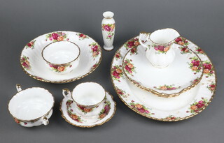 An 89 piece Royal Albert Old Country Rose pattern dinner/tea service comprising oval meat plate, 15 dinner plates, 9 side plates, 9 pudding bowls, 6 small circular dishes, 2 bread plates, large circular bowl, 4 twin handled soup bowls and saucers, cream jug, sugar bowl, 2 small oval twin handled dishes, an oval shaped dish, 18 cups, 15 saucers, together with a similar unmarked specimen vase 