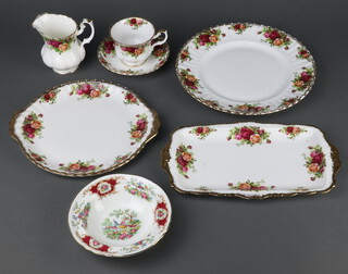 A Royal Albert Old Country Roses pattern part tea and dinner service comprising 5 tea cups, 6 saucers, 6 small plates, 5 side plates, 7 dinner plates, a sandwich plate and milk jug, a rectangular plate and 6 Foley dessert bowls 