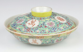 A Chinese antique style circular bowl and cover, the green ground decorated formal flowers and panels of mons, the base and lid both with a red 4 character mark 26cm