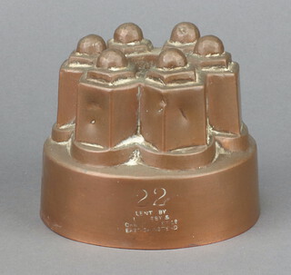 A 19th Century circular copper jelly mould marked 22, lent by Leatherby and Christopher, East Grinstead 9cm x 12cm 