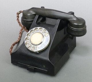 A black Bakelite dial telephone base marked R32L C248/2 