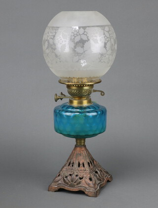 A Victorian blue glass oil lamp reservoir raised on a pierced metal waisted base 30cm together with an associated etched glass shade (light chips to base) 