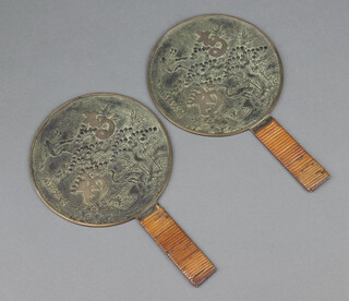 A pair of 19th Century circular Japanese polished bronze hand mirrors decorated stork with bamboo bound handles 36cm  