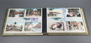 An early 20th Century Japanese black lacquered postcard album complete containing various coloured postcards of Japanese locations and ladies in formal attire  
