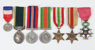 A George VI issue Territorial Efficiency medal to 2052155 Gunner HMM Mackinney Royal Artillery together with an Italy Star, Africa Star, Defence and War medal and a French Legion of Honour together with a French medal Minister Travail named to E Courbe 1959 