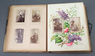 A Victorian musical family portrait photograph album bound in burgundy calf, the front board decorated a gilt Roman urn containing flowers, flanked by a pair of birds, fitted a faux locking clasp that is an activating lever when opened for the musical box, dedication to inside cover dated July 20th 1883, 4to., the album containing 12 pages of photographs 