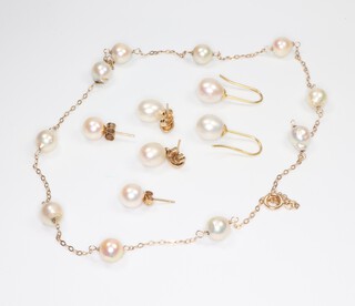 A yellow metal 14k cultured pearl necklace 36cm and 3 pairs of pearl earrings 