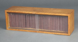 The Temple Shakespeare, London JM Dent 1920's, a collection of 41 volumes of Shakespeare's works in burgundy cloth bound 12mo. editions contained in a fitted oak framed case with sliding glass doors 