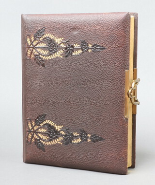 A Victorian carte de visit album with embossed floral cover, gilt metal mounts and coloured pages 