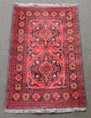 A black and red ground Afghan rug with diamonds to the centre 151cm x 98cm 