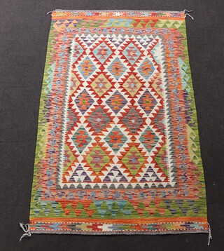 A white, turquoise and green ground Maimana Kilim rug with diamond design to the central field 204cm x 129cm 